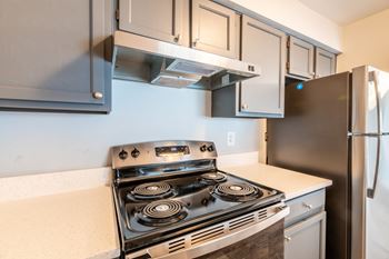 A modern kitchen with a stove and refrigerator at BellaVista Apartments in Woodbridge, VA